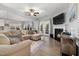 Bright living room with a fireplace, ceiling fan, hardwood floors, and ample natural light at 176 E Ravano Dr, Clayton, NC 27527