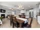 Open-concept living space with a dining area, kitchen, and cozy living room with a fireplace at 176 E Ravano Dr, Clayton, NC 27527