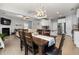 Open-concept living space with a dining area, kitchen, and cozy living room with a fireplace at 176 E Ravano Dr, Clayton, NC 27527