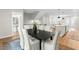 Dining area adjacent to modern kitchen with wood floors and plenty of natural light at 1858 Fahey Dr, Apex, NC 27502