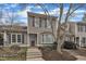 Charming townhouse featuring neutral siding, blue shutters, and a well-manicured front yard at 2 Forest Green Dr, Durham, NC 27705