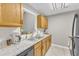 The kitchen has stainless appliances, granite counters and wood cabinets, along with a view to another room at 2 Forest Green Dr, Durham, NC 27705