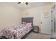 Small bedroom with a grey headboard bed, pink decor, a door, and a ceiling fan at 205 Sarazen Dr, Clayton, NC 27527