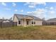 Backyard view of home with covered porch and wood privacy fence at 229 S Prince Henry Way Way, Cameron, NC 28326