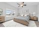 Bright bedroom with neutral decor featuring a ceiling fan, large windows, and stylish furnishings at 229 S Prince Henry Way Way, Cameron, NC 28326