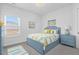 Bright bedroom with a light-blue bed, matching nightstand, and nautical artwork at 229 S Prince Henry Way Way, Cameron, NC 28326