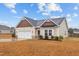 Well-maintained single-story home with neatly landscaped front yard and attached garage, in a suburban setting at 229 S Prince Henry Way Way, Cameron, NC 28326