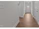 Hallway featuring wood-look flooring, fresh neutral paint, and views of the home's front entrance at 229 S Prince Henry Way Way, Cameron, NC 28326