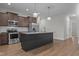 Well-equipped kitchen featuring a large island with seating, stainless appliances, and stylish pendant lights at 229 S Prince Henry Way Way, Cameron, NC 28326