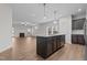 Spacious kitchen featuring dark cabinetry, a center island, pendant lighting, and stainless appliances at 229 S Prince Henry Way Way, Cameron, NC 28326