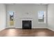 Neutral living room featuring a fireplace, access to the backyard, and a window for natural light at 229 S Prince Henry Way Way, Cameron, NC 28326