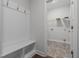 Mudroom with a built-in bench and storage, leading into a laundry room with utility connections at 229 S Prince Henry Way Way, Cameron, NC 28326