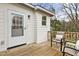 Inviting back porch with a quaint seating area overlooking the wooded scenery at 2305 Fitzgerald Ave, Durham, NC 27707