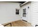 Cozy back porch with white exterior and a charming white door at 2305 Fitzgerald Ave, Durham, NC 27707