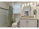 Bright bathroom with white tile, vanity, and shower at 2305 Fitzgerald Ave, Durham, NC 27707