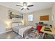 Bedroom with a large bed, cityscape wall art, desk and ceiling fan at 2305 Fitzgerald Ave, Durham, NC 27707