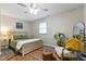 Comfortable bedroom with neutral walls, wood-look bed frame, an area rug, and gray flooring at 2305 Fitzgerald Ave, Durham, NC 27707
