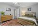 Cozy bedroom featuring wood-look bed frame and dresser on an area rug and gray flooring at 2305 Fitzgerald Ave, Durham, NC 27707