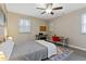 Comfortable bedroom featuring a ceiling fan, natural light, and a functional workspace at 2305 Fitzgerald Ave, Durham, NC 27707