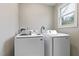 Functional laundry room with modern washing machine and dryer units for efficient laundry care at 2305 Fitzgerald Ave, Durham, NC 27707