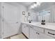 Bright bathroom featuring a double sink vanity, white cabinets, and framed mirror at 240 Forest Meadow Ln, Franklinton, NC 27525