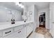 Bright bathroom with a double sink vanity, neutral walls, and white cabinets offering serene ambiance at 240 Forest Meadow Ln, Franklinton, NC 27525