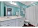 Well-lit bathroom featuring dual sinks, ample counter space, and a shower with a white curtain at 240 Forest Meadow Ln, Franklinton, NC 27525