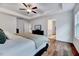 Bright bedroom featuring two windows, recessed ceiling, and wood look floors with an ensuite bath at 240 Forest Meadow Ln, Franklinton, NC 27525