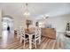 Dining area open to living room with a modern chandelier, wood floors, and comfortable furnishings at 240 Forest Meadow Ln, Franklinton, NC 27525