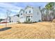 Side view of a gray two-story home showcasing the manicured lawn and fence in the backyard at 240 Forest Meadow Ln, Franklinton, NC 27525