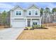 Charming two-story home with gray siding, a two-car garage and meticulously manicured landscaping at 240 Forest Meadow Ln, Franklinton, NC 27525