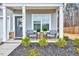 Inviting front porch with seating, decorative plants, and a view of the landscaped front yard at 240 Forest Meadow Ln, Franklinton, NC 27525
