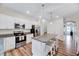 Well-lit kitchen featuring an island with seating, modern appliances, and neutral decor at 240 Forest Meadow Ln, Franklinton, NC 27525