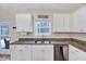 Kitchen details including granite countertops, stainless steel dishwasher, white cabinets, and natural light at 240 Forest Meadow Ln, Franklinton, NC 27525