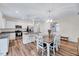 Bright, modern kitchen featuring white cabinetry, stainless steel appliances, and a granite-topped island with seating at 240 Forest Meadow Ln, Franklinton, NC 27525