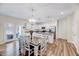 Open-concept kitchen with white cabinets, stainless appliances, island and a dining area with stylish lighting at 240 Forest Meadow Ln, Franklinton, NC 27525