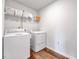 Well-lit laundry room with modern washer and dryer set, accompanied by wire racks and shelves at 240 Forest Meadow Ln, Franklinton, NC 27525