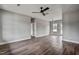 Spacious living room with hardwood floors, ceiling fan, and neutral gray walls at 2513 Rolesville Rd, Wake Forest, NC 27587