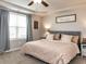 Bright bedroom with tray ceiling, large window, and neutral decor at 258 Denning Farms Ln, Benson, NC 27504