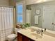 Well-lit bathroom features a large vanity and a bright window with plantation shutters at 2631 Cloud Mist Cir, Raleigh, NC 27614