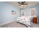 Bedroom featuring a floral comforter on the bed, carpet, and two windows at 2713 Penfold Ln, Wake Forest, NC 27587