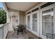 Inviting balcony with a cozy seating area and charming view through the white-trimmed doors at 2810 Bedford Green Dr # 300, Raleigh, NC 27604