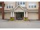 Inviting building entrance featuring double doors, white columns, and two attached garages on either side of the entryway at 2810 Bedford Green Dr # 300, Raleigh, NC 27604