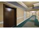 Elevator and hallway with neutral wall colors and carpeting that lead to individual units offering peace and privacy at 2810 Bedford Green Dr # 300, Raleigh, NC 27604