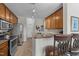 Cozy kitchen with stainless steel appliances, wooden cabinets, and barstool seating at the granite countertop at 2810 Bedford Green Dr # 300, Raleigh, NC 27604
