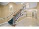 Beautifully maintained common stairwell features tiled floors, carpeted stairs, and wood-and-white banisters in the building at 2810 Bedford Green Dr # 300, Raleigh, NC 27604