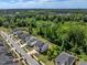 Aerial view of new homes in a suburban community near lush green trees and a small pond at 2981 Thurman Dairy Loop, Wake Forest, NC 27587