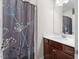 Bathroom featuring decorative shower curtain, white walls, vanity and mirror at 2981 Thurman Dairy Loop, Wake Forest, NC 27587