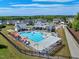 Aerial view of neighborhood pool featuring sun loungers, shaded seating, and clubhouse at 2981 Thurman Dairy Loop, Wake Forest, NC 27587