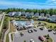 Aerial view of neighborhood pool featuring sun loungers, shaded seating, clubhouse and playground at 2981 Thurman Dairy Loop, Wake Forest, NC 27587